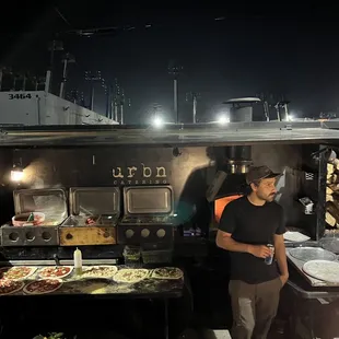 a group of people standing in front of a food truck