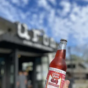 a person holding a bottle of beer