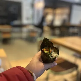 a person holding a piece of food in their hand