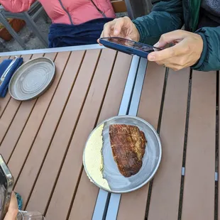 two people sitting at a table with plates of food