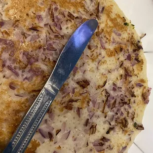 a pizza with onions and cheese