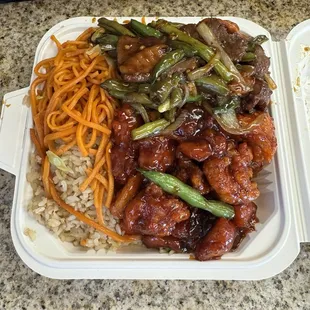 Half and half chow mein and rice with orange chicken and green bean chicken