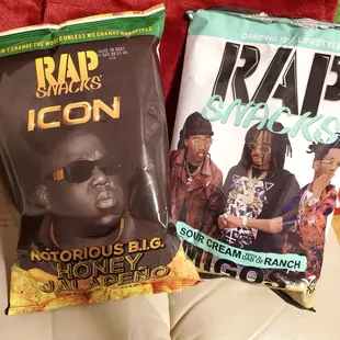 two bags of rap snacks on a couch