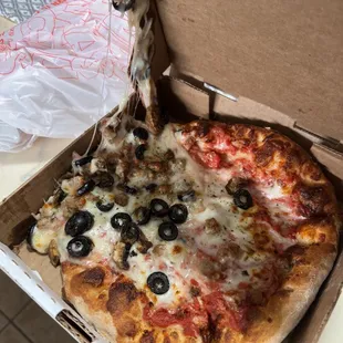 a pizza with olives and cheese