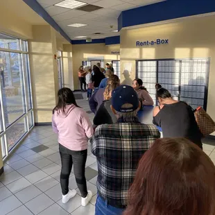 People in line to pick up a package. Why does it take so long?