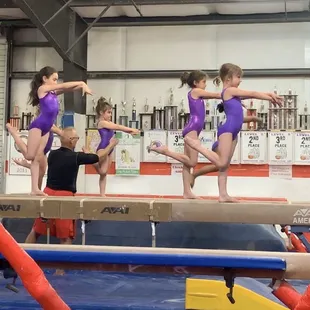 Jim coaching the level 2 on beam.