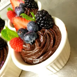 chocolate cupcakes with berries and mint leaves