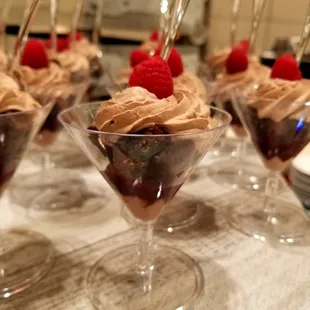 desserts in martini glasses with raspberries on top