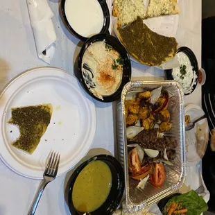 Mix grill. Hummus, tabouleh , garlic sauce, tahini sauce, Zaatar and Cheese Flatbread Pizza, Bread, Yogurt Salad, Lentil Soup