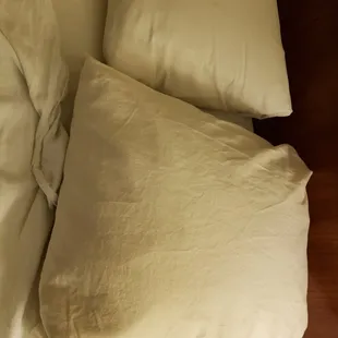 One almost brown pillow case on this bed!