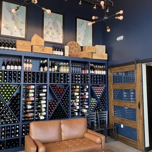a couch in front of a wine rack