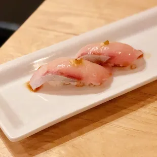a plate of sushi on a wooden table