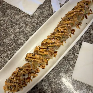 a long roll of sushi on a plate