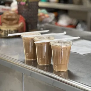 four cups of coffee on a counter