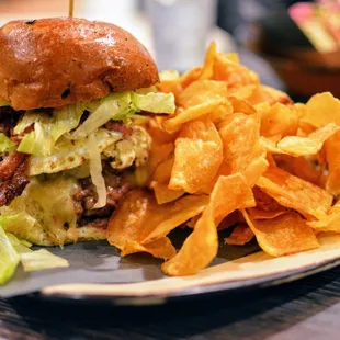 Handcrafted Double Burger - Topped with  cheese, lettuce, tomato, onion, bacon, egg, and pastrami on onion roll.