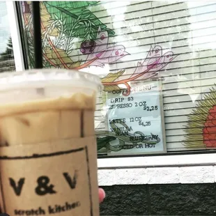 a hand holding a cup of coffee