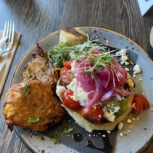 Avocado toast on homemade english muffin with a side of potato cakes