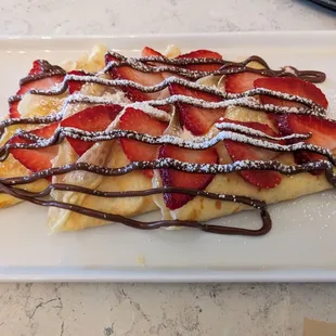 Brunch crepe with strawberries, sweet cream cheese, and nutella