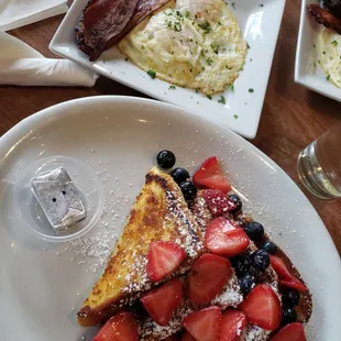 Waffles with berries and bacon/eggs on the side