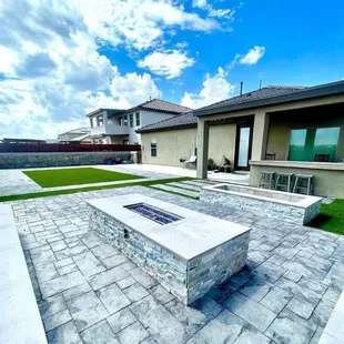 a patio with a fire pit
