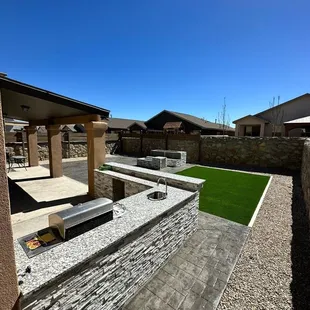 a patio with seating and a fire pit
