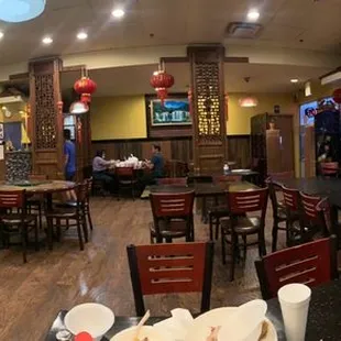 the inside of a restaurant with tables and chairs