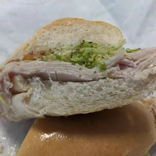 Thinly-sliced turkey on a crusty roll.