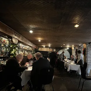 people sitting at tables in a restaurant