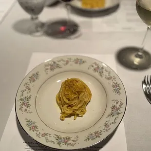 a plate of pasta and a glass of wine