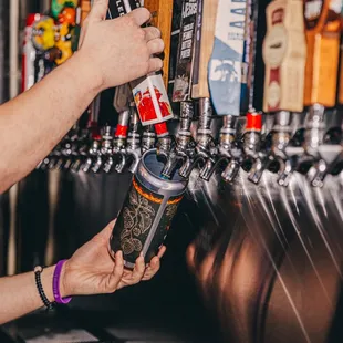 a woman filling up a beer
