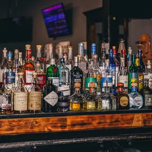a variety of liquor bottles on a bar