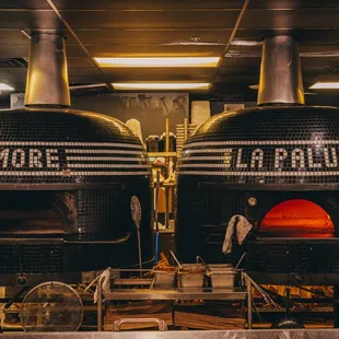 two pizza ovens in a kitchen