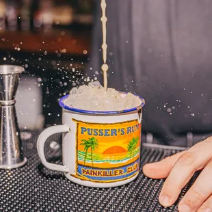 a person pouring a drink