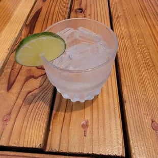 a drink in a glass with a lime wedge