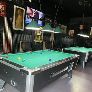 two pool tables and a television