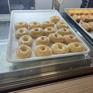 a tray of glazed donuts