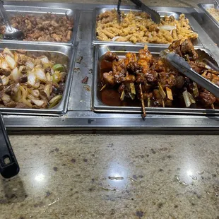 Barbecue chicken on a stick and pepper steak.