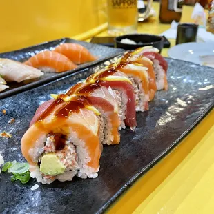a variety of sushi on a black plate