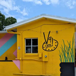 a yellow building with a sign painted on it