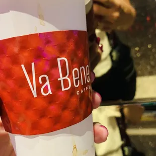 a person holding a cup of coffee