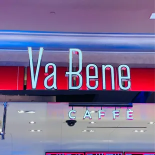 a neon sign above a coffee shop