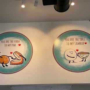 a couple of paintings on a wall