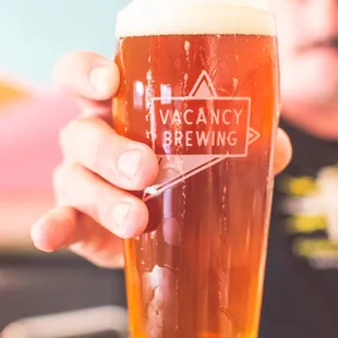 a man holding a pint of beer