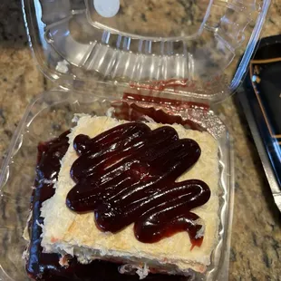 Some type of layered tart with Raspberry jam and custard