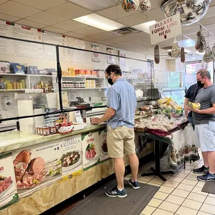 two men standing in a grocery store