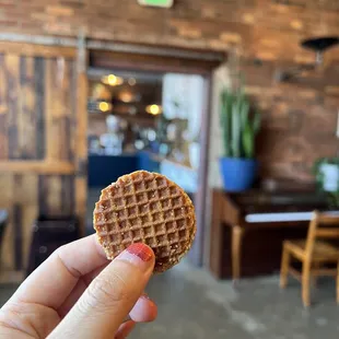 a hand holding a waffle