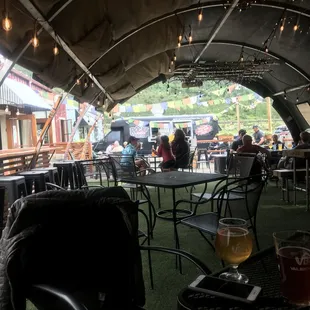 The covered outside area.  There is an uncovered area between this and the food truck.