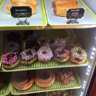 a variety of donuts in a display case