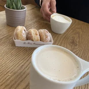 a cup of coffee and a box of doughnuts