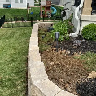 a garden with a retaining wall